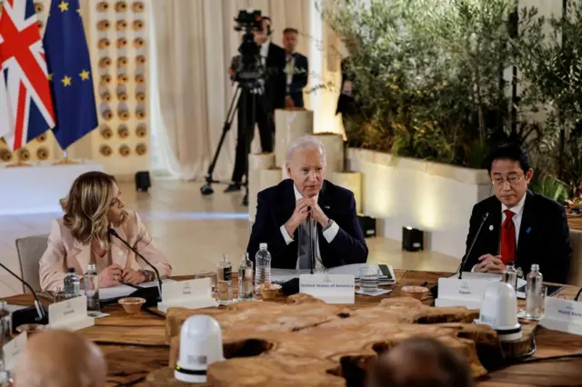 Italian Prime Minister Giorgia Meloni (L), US President Joe Biden (C) and Japanese Prime Minister Fumio Kishida (R) attend a meeting at the G7 Summit in Italy