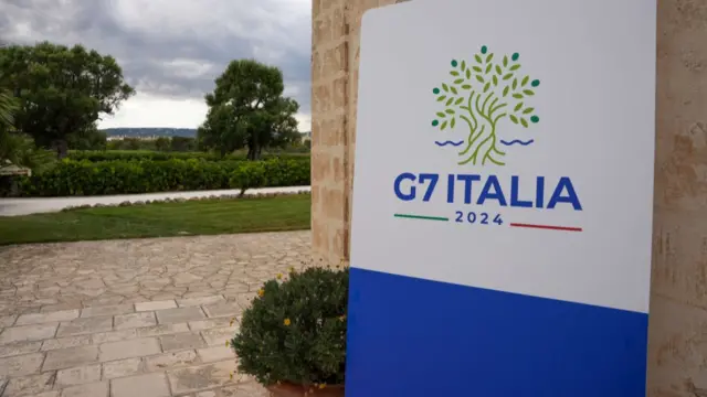 Logo for the 2024 G7 Summit in Italy is seen on a sign outside