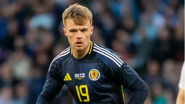 Tommy Conway running on the pitch during Scotland's friendly with Finland