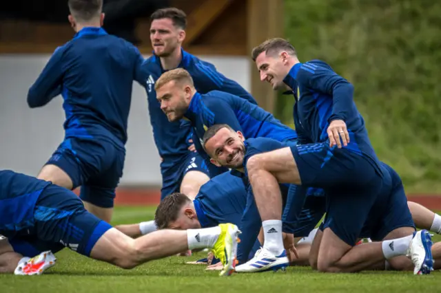 John McGinn cracks a smile among team mates while stretching