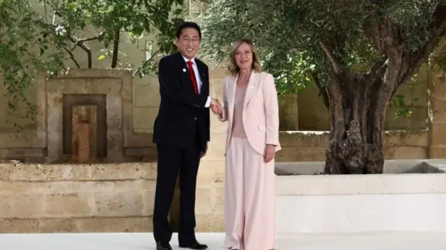 Japanese Prime Minister Fumio Kishida shakes hands with Giorgia Meloni