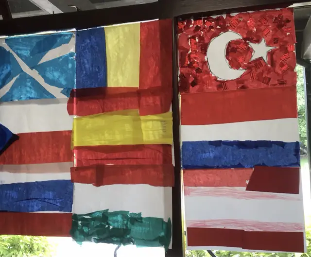 Painted flags of Scotland, Czechia, Russia, Slovenia, Spain, Hungary, Turkey, Netherlands and Latvia on a window