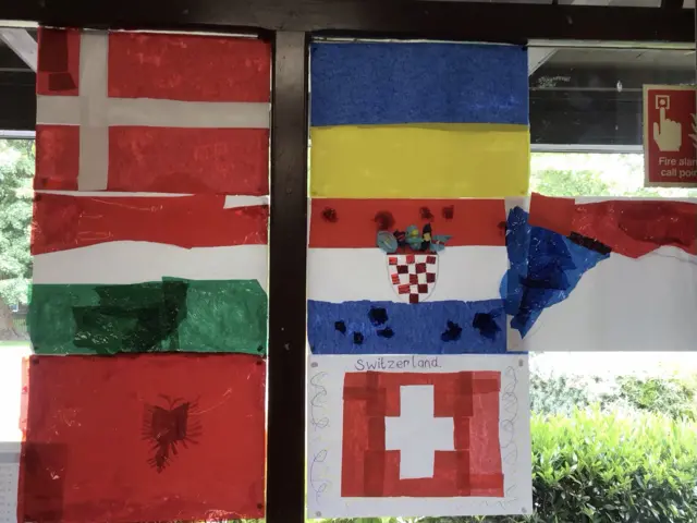 Painted flags of Denmark, Hungary, Albania, Ukraine, Croatia on a window