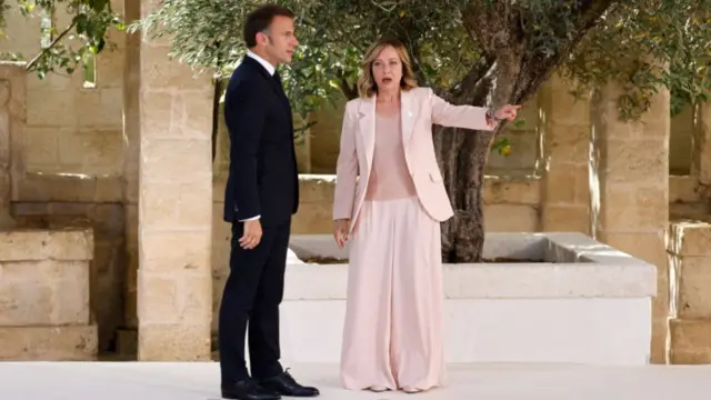 French President Emmanuel Macron is welcomed by Italy's Prime Minister Giorgia Meloni upon arrival at the Borgo Egnazia resort for the G7 Summit hosted by Italy in Apulia region, on June 13, 2024