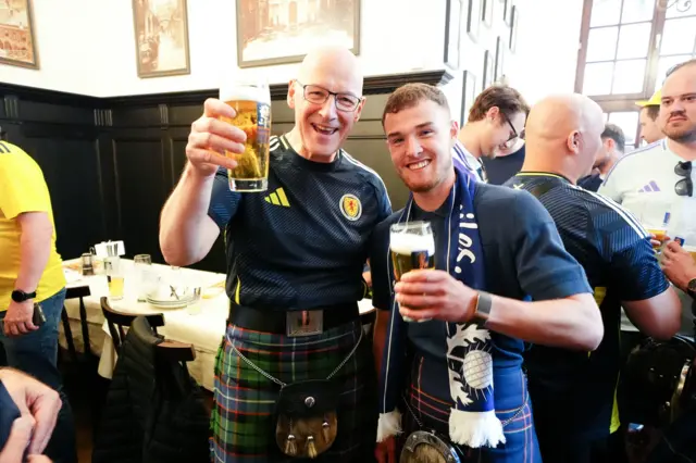 Scotland fan Craig Ferguson (right), who has walked from Scotland to Germany for Euro 2024 with First Minister of Scotland John Swinney at Marienplatz squar