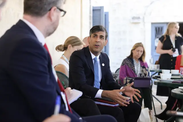 Landscape shot of Rishi Sunak speaking in media huddle