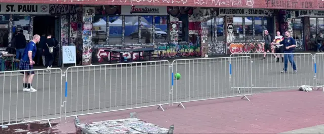 Scotland fans playing football outside the St Pauli stadium in Hamburg