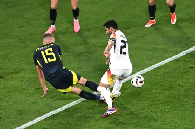 Ryan Porteous (L) tackles Germany's midfielder #21 Ilkay Gundogan in the penalty area during the UEFA Euro 2024 Group A football match between Germany and Scotland at the Munich Football Arena