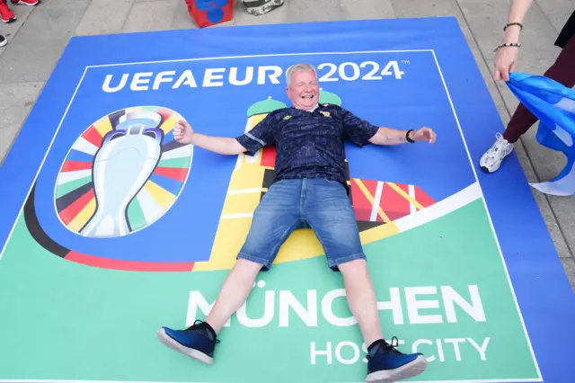 A Scotland fan on a Euro 2024 flag