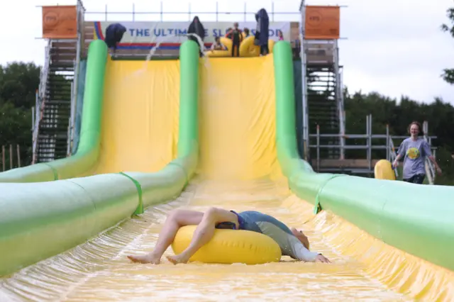 Ed Davey on a water slide