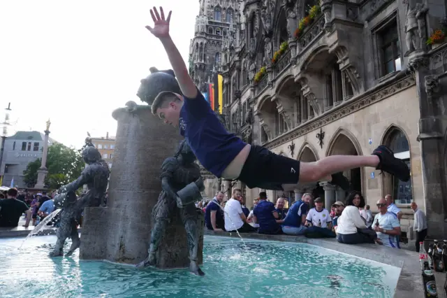 A Scotland fan dives into a fountain in Munich before their game against Germany at Euro 2024