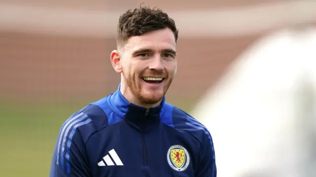 Andy Robertson smiles during Scotland training