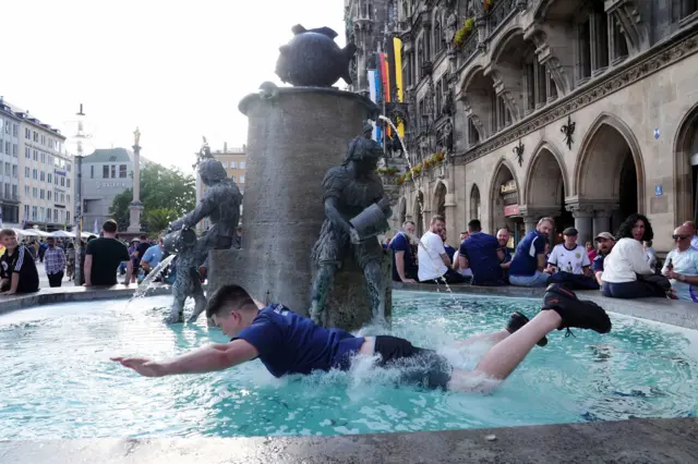 A Scotland fan dives into a fountain in Munich before their game against Germany at Euro 2024