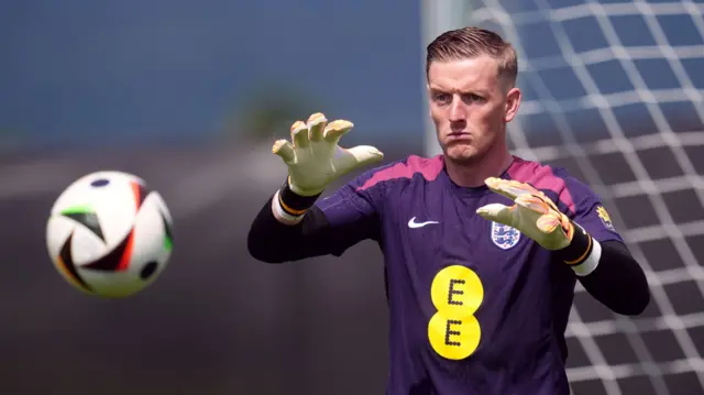 Goalkeeper Jordan Pickford prepares to catch the ball during England training at Euro 2024