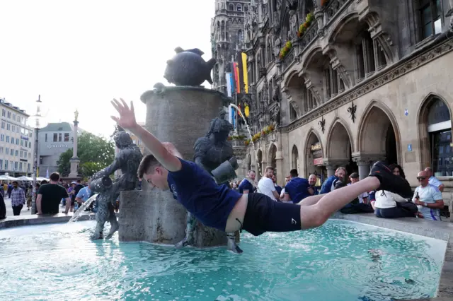 A Scotland fan dives into a fountain in Munich before their game against Germany at Euro 2024