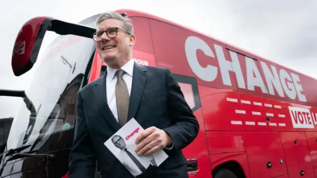 Labour Party leader Sir Keir Starmer arrives on board his election battle bus at a campaign event