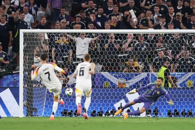 Angus Gunn of Scotland dives and fails to save the shot of Kai Havertz of Germany which results in a third Germany goal during the UEFA EURO 2024 group stage match between Germany and Scotland at Munich Football Arena