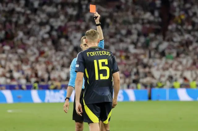 Referee Clement Turpin shows a red card to Ryan Porteous of Scotland during the UEFA EURO 2024 group A match between Germany and Scotland in Munich, Germany