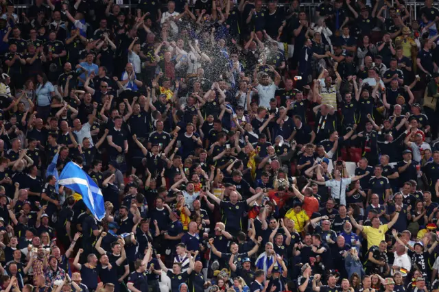 Fans of Scotland celebrate after Antonio Ruediger of Germany (not pictured) scores an own-goal during the UEFA EURO 2024 group stage match between Germany and Scotland at Munich Football Arena