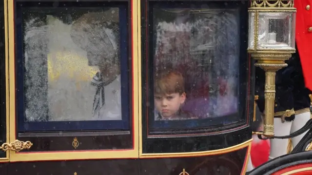 Prince Louis looks out from a carriage window