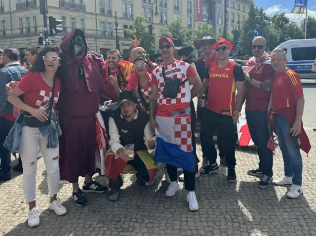 A group of Spanish and Croatian fans pose together in Berlin