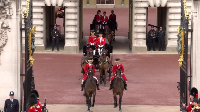 Carriages carrying senior members of the Royal family leave the Buckingham Palace