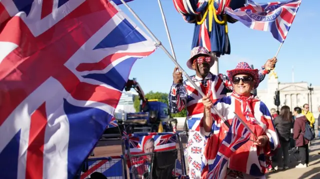 Royal watchers gather on The Mall ahead of Trooping the Colour