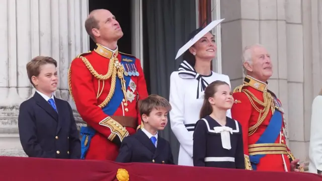 Prince William, Princess Catherine and King Charles watch the RAF flypast with Prince William's and Kate's children looking on.