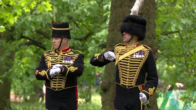 The gun salute at Green Park, soldiers stand in regalia.