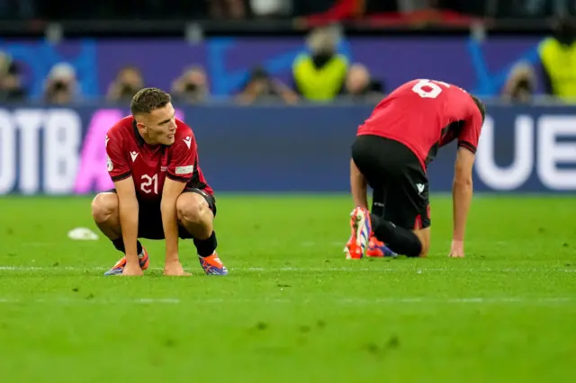 Albania players sink to the floor at the full time whistle