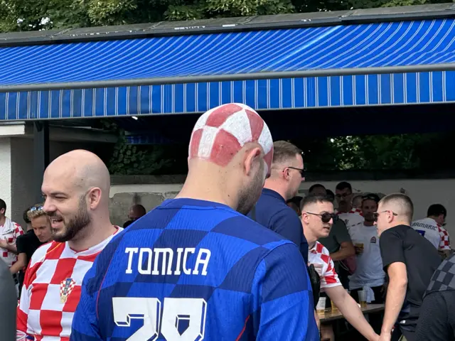 A Croatian fan with chequered paint on his head