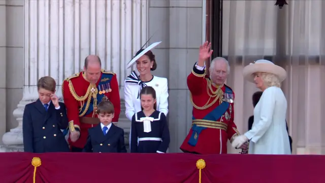 The Royal Family waves before returning inside.