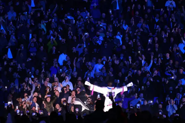 Richard Riakporhe holds his arms out to the crowd