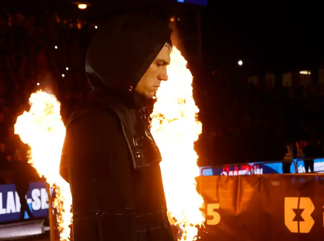 Chris Billam-Smith dressed in black makes his ring walk and passes by fireworks