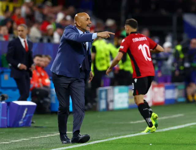 Spaletti shouts and points instructions from the touchline