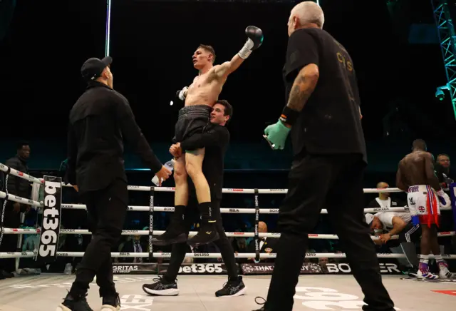 Shane McGuigan lifts Chris Billam-Smith in the air