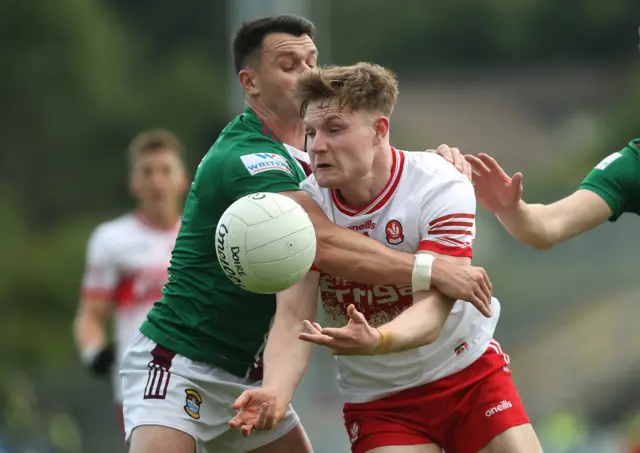 Ethan Doherty is challenged for the ball