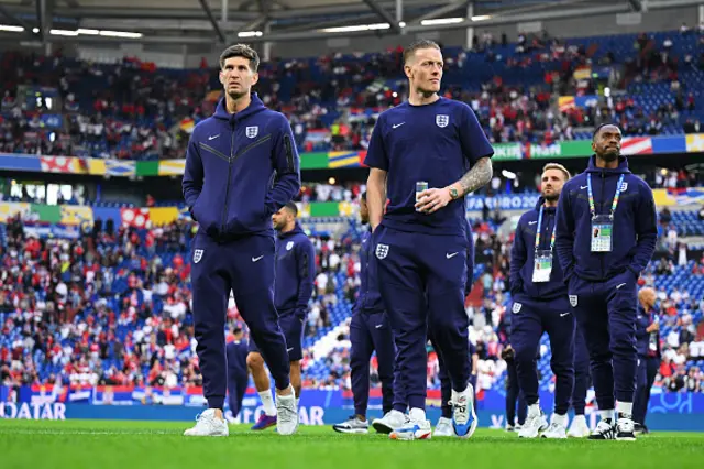 John Stones and Jordan Pickford of England inspect the pitch