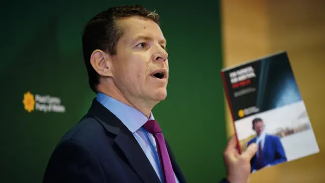 Rhun ap Iorwerth hold up his party's General Election manifesto