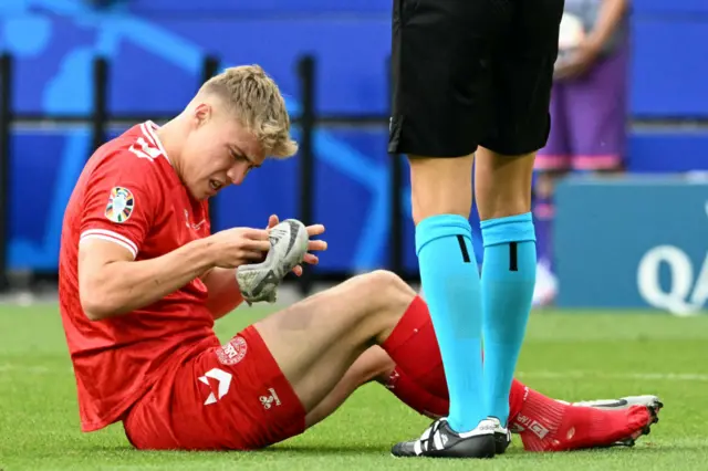 Rasmus Hojlund holding his football boot