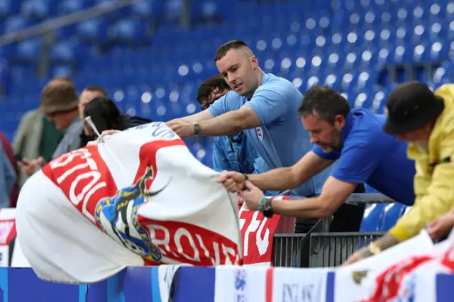 England fans put flags up inside the stadium