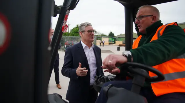 Labour leader Sir Keir Starmer speaks with Martin, a forklift truck driver, during a visit to C&W Berry's Builders Merchants, Lancashire, as he sets out his party's plans to create jobs through Labour's Green Prosperity Plan, while on the General Election campaign trail. Picture date: Friday May 24, 2024.