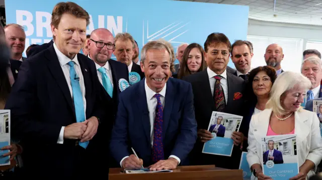 Nigel Farage stands with Reform UK candidates and supporters