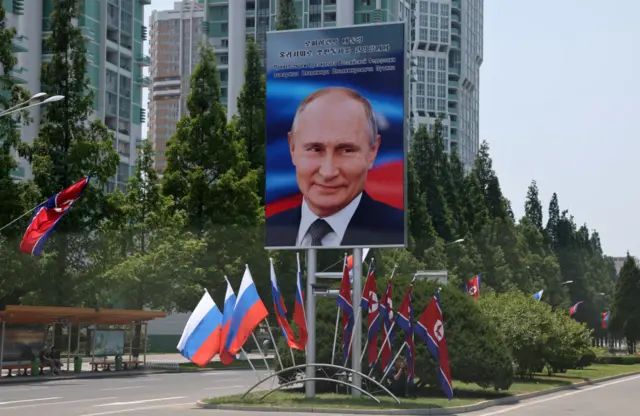 A picture of Russia's President Vladimir Putin on a billboard is seen on the street in Pyongyang.