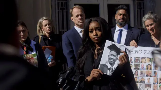 Zipporah Kuria holds a photo of her father, who died in a Boeing airplane crash