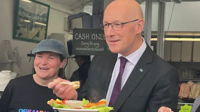 Swinney poses with food