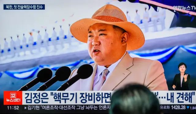 A TV screen shows an image of North Korean leader Kim Jong Un delivering a speech during a ceremony on September 6 2023