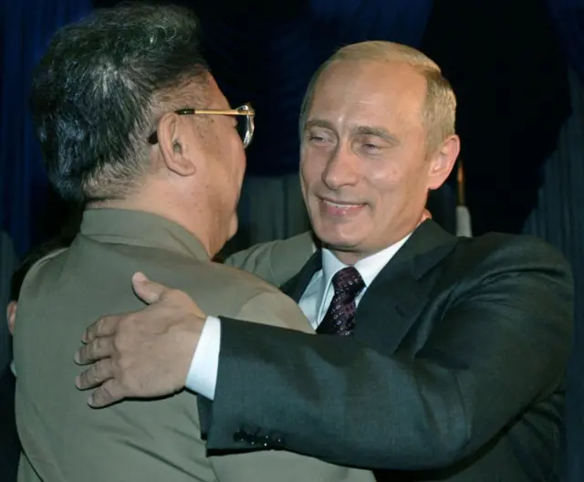 Kim Jong II hugs Vladimir Putin