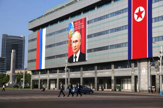 A picture of Russia's President Vladimir Putin on a billboard is seen on a building in Pyongyang.