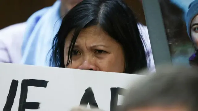 Clariss Moore, whose daughter Danielle was killed in a Boeing crash in 2019, holds a sign at the hearing